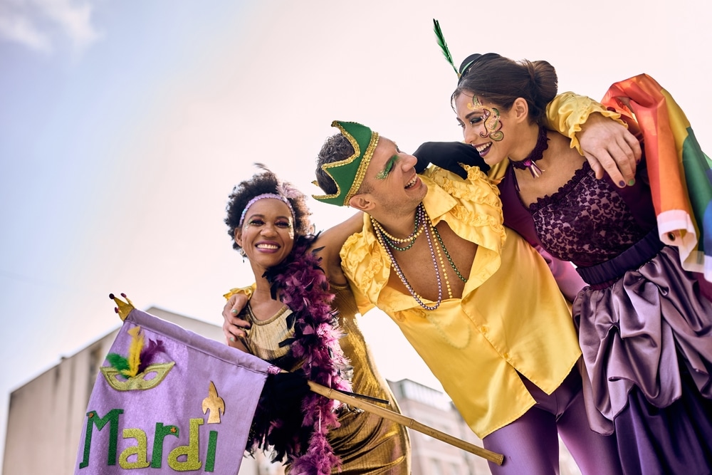 Low,Angle,View,Of,Cheerful,Friends,Wearing,Mardi,Gras,Costumes